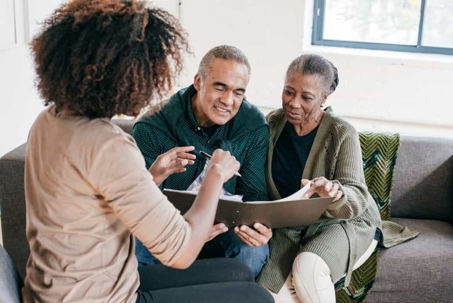 Older couple goes over paperwork with their adult daughter